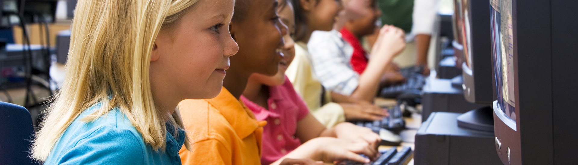 Kindergarten children learning how to use computers.